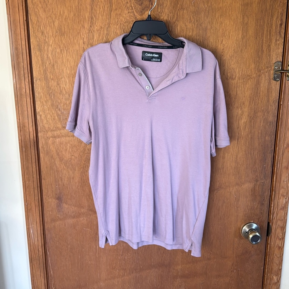 Golf shirt by Calvin Klein size medium in a lavender gray color.